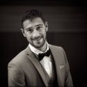 Groom's smile in portrait, before leaving for his ceremony, by the wedding photographer in Cascais, Portugal.