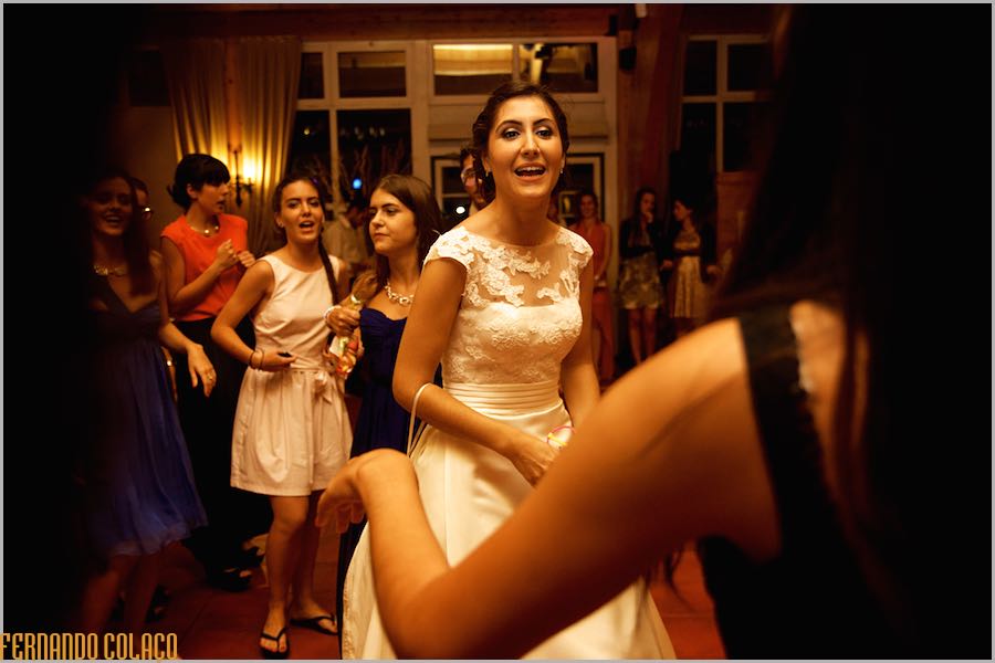 The bride dances among her friends, during her wedding party at Quinta do Lumarinho, as captured by the wedding photographer in Lisbon, Portugal.