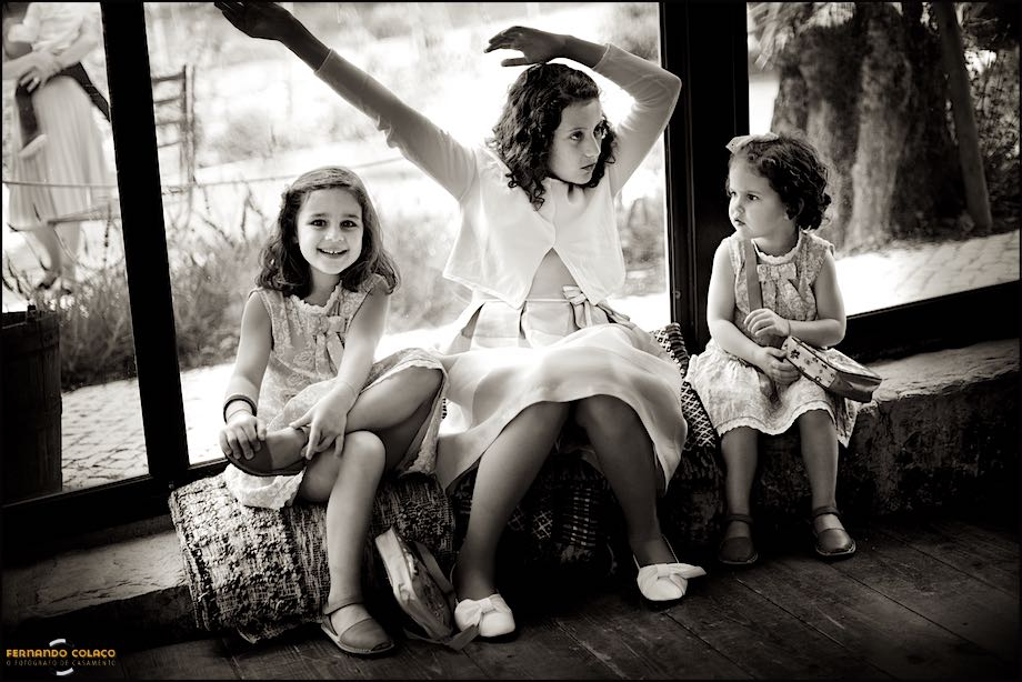 Three little girls seated in the wedding party room.