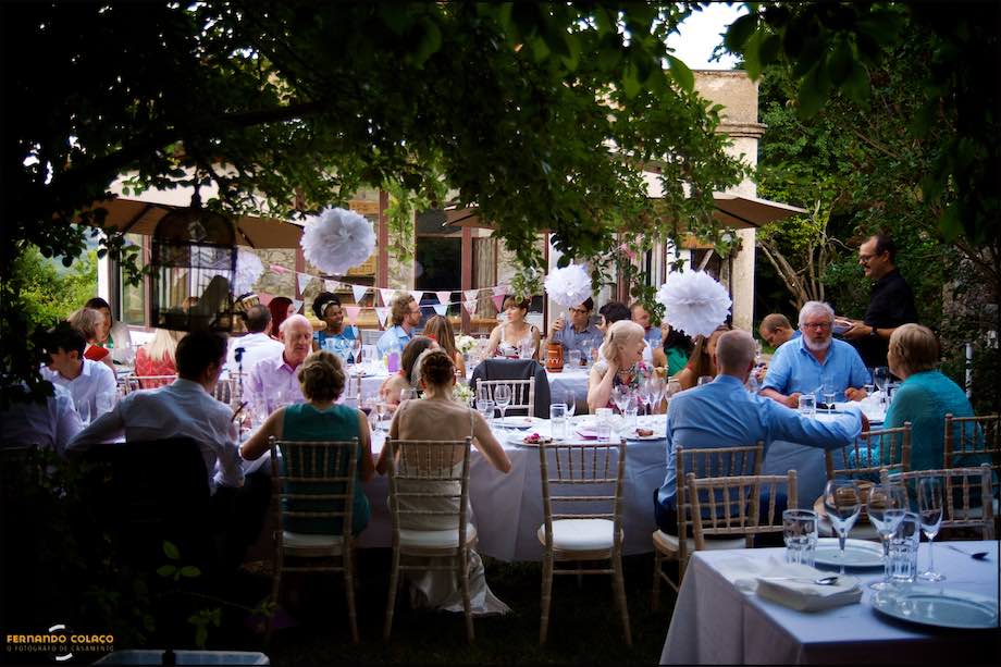 Overview of the tables full of guests celebrating the wedding, at sunset in an old Villa in Monchique, Algarve.