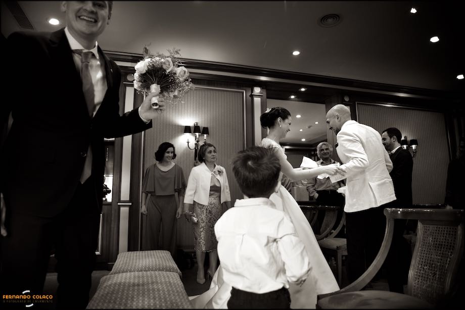 Bride and groom and guests in the Hotel Palácio Estoril room after the wedding ceremony.