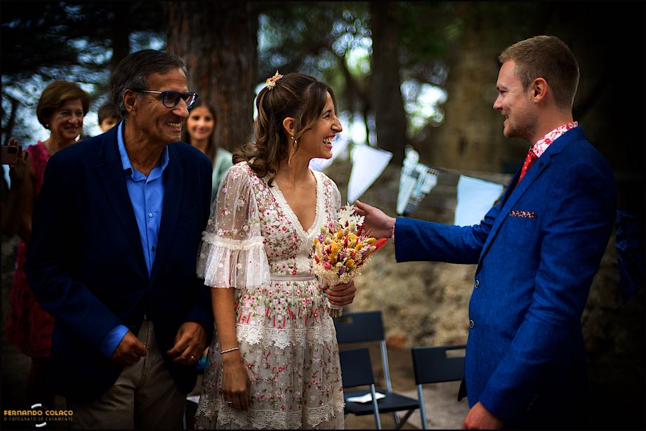 The groom receives the bride and her father who laugh with satisfaction, to begin the wedding ceremony at St. George's Castle in Lisbon.