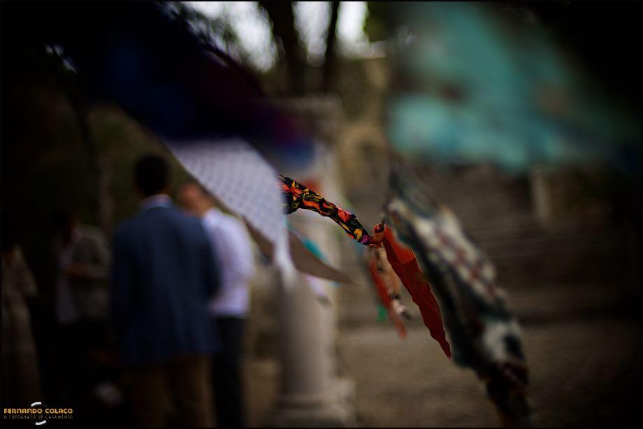 Fluttering flags, flying in the wind, decorated the wedding ceremony venue, in a composition by the wedding photographer.