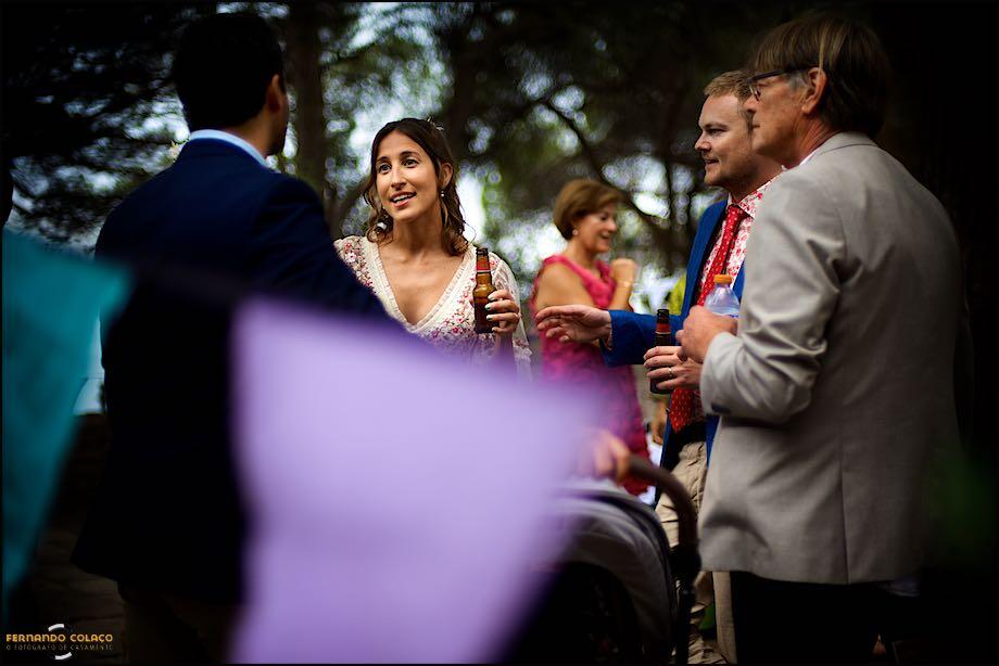 The bride and groom chatted with the best man and the groom's father, seen by the Lisbon wedding photographer at St George's Castle in Lisbon where the wedding ceremony was.