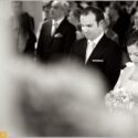 In front of the church altar, the bridal couple in a moment of introspection in a part of the ceremony, was captured by the wedding photographer in Lisbon.