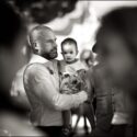 On the lap of her attentive uncle, seen among the guests, the bride and groom's baby daughter felt safe at all times during the wedding party in Agostos, in the Algarve.