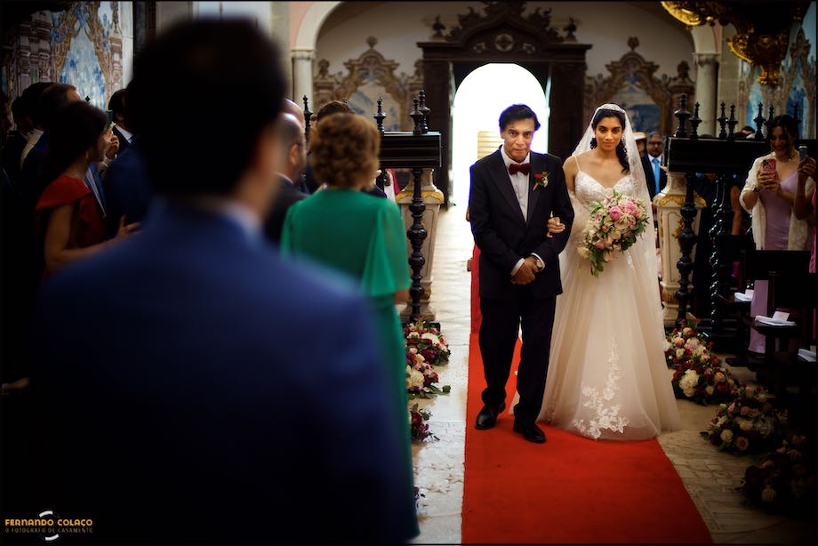 The bride and her father arrive with the groom for the wedding ceremony at the Convento do Espinheiro church in Évora.