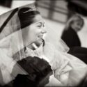 Já sentada no automóvel, a nova ri de satisfação momentos antes de partir para a cerimónia, conforme a viu o fotógrafo de casamento em Almada.