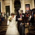 After the wedding ceremony in the Basilica of Mafra, the bride and groom walk out among the guests who throw grains of rice at them.