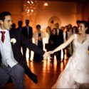 The bride and groom standing next to each other, looking into each other's eyes and holding hands during part of the choreography for the first dance at the opening of the ball at Casa de Reguengos.