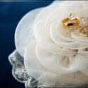 The wedding rings in a satin flower, as if they were in a nest, as seen by the wedding photographer in Fatima.