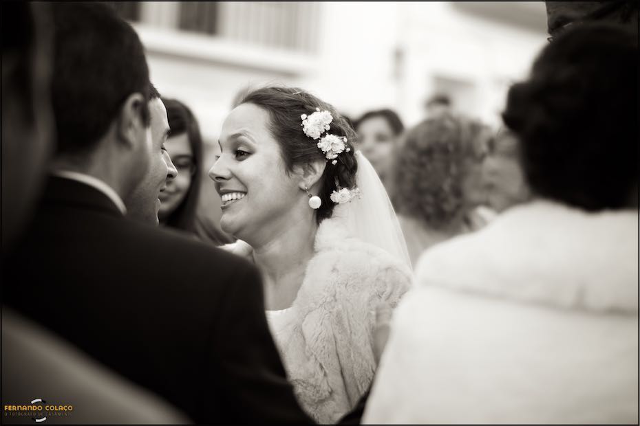 The bride among guests congratulating her after the wedding ceremony.